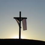 Picture of cross on hill with sash draped around