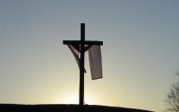 Picture of cross on hill with sash draped around