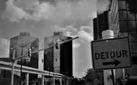 Picture of Detour sign with city buildings in the background